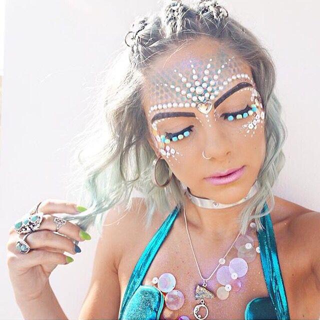 An image of a woman showing her festival makeup look including glitter and gems