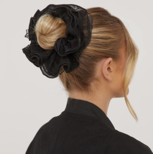 blonde lady wearing her hair in a bun with a black lace hair scrunchie