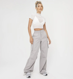 blonde lady wearing white baby tee with high waist grey trousers