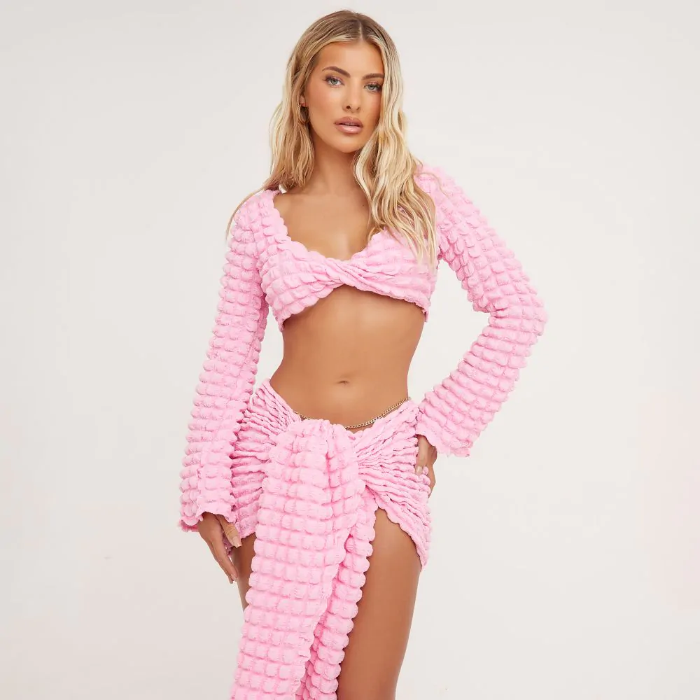 LONG SLEEVE TWIST FRONT DETAIL CROP TOP IN PINK BUBBLE TEXTURED MATERIAL